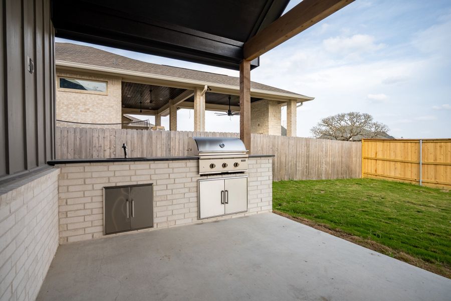 Exterior details and patio area of a home in Greens Prairie Reserve, College Station (Image 34).