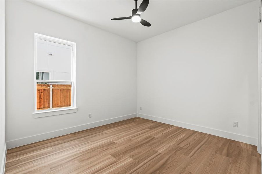 Unfurnished room featuring wood finished floors and a ceiling fan