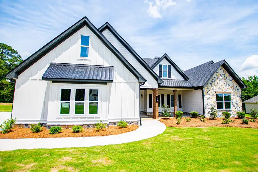 Front exterior of a new home in WOODMONT RESERVE, Roopville, GA, highlighting curb appeal (Image 32).