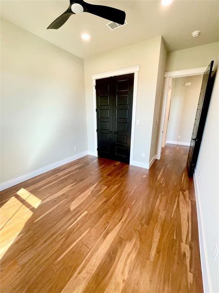 Fourth bedroom with light wood-style flooring, a ceiling fan, recessed lighting, and a closet