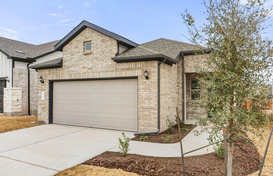 Front exterior of a new home in Saddleback at Santa Rita Ranch, Liberty Hill, TX, highlighting curb appeal (Image 16).