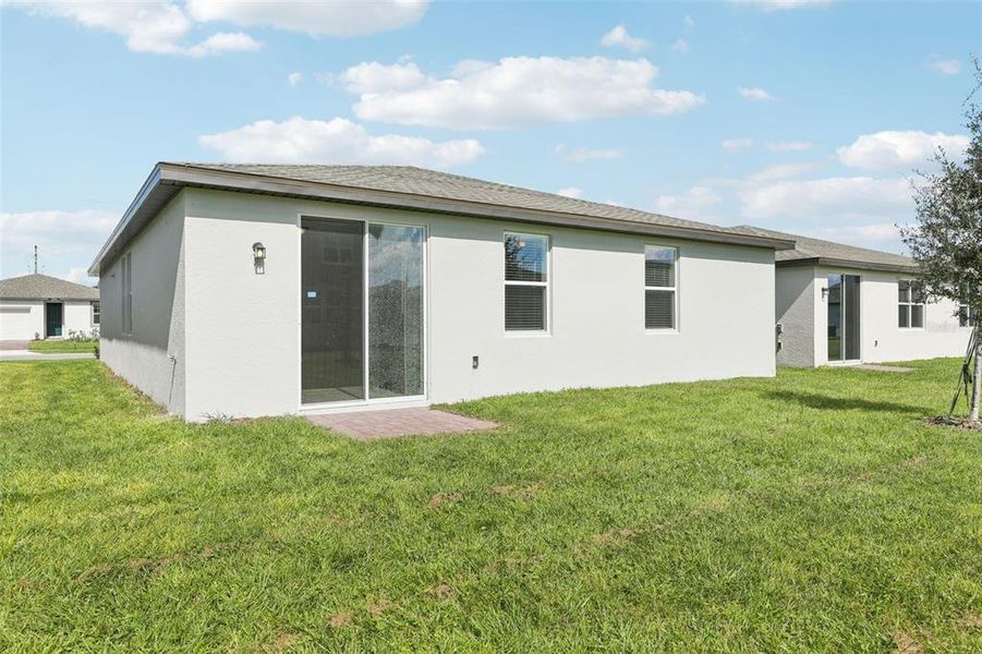 Exterior details and patio area of a home in Lawson Dunes - Signature Series, Haines City (Image 28).