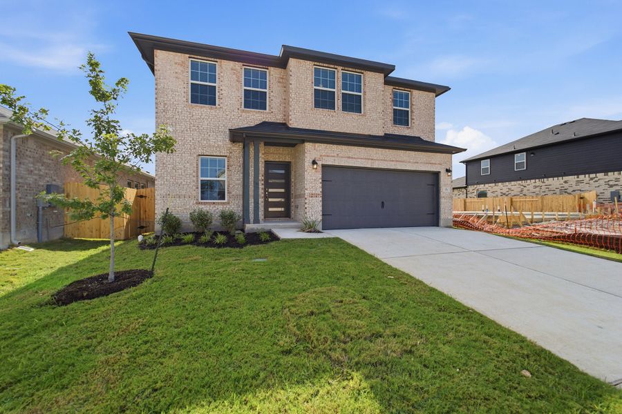 Front exterior of a new home in Sunfield, Buda, TX, highlighting curb appeal (Image 2). Front exterior of a new home in Sunfield, Buda, TX, highlighting curb appeal (Image 2).