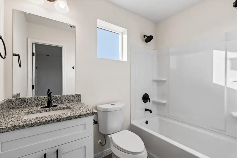 The primary bathroom offers a calm, private space to start and end your day with ease.