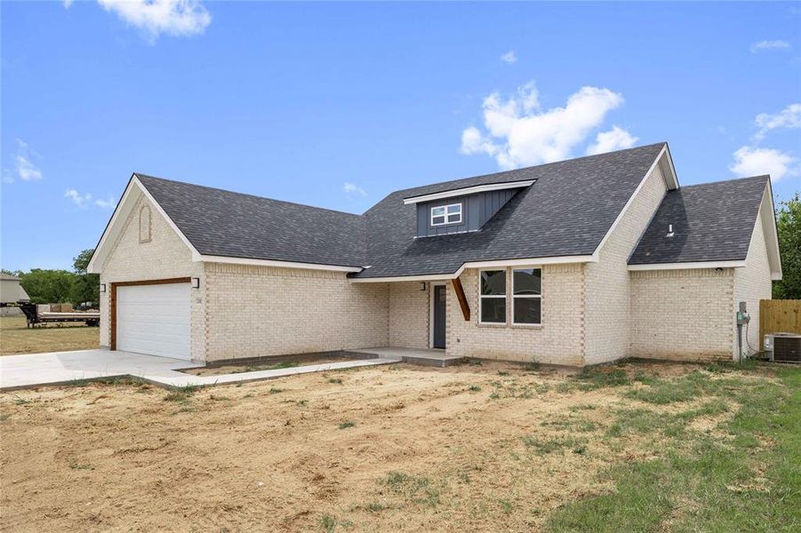 View of front of property featuring brick siding, driveway, an attached garage, roof with shingles, and covered porch View of front of property featuring brick siding, driveway, an attached garage, roof with shingles, and covered porch