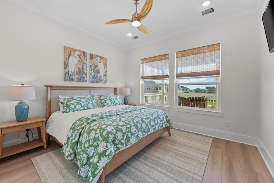 Wake up to natural light and scenic pond views in this first floor primary bedroom. Wake up to natural light and scenic pond views in this first floor primary bedroom.