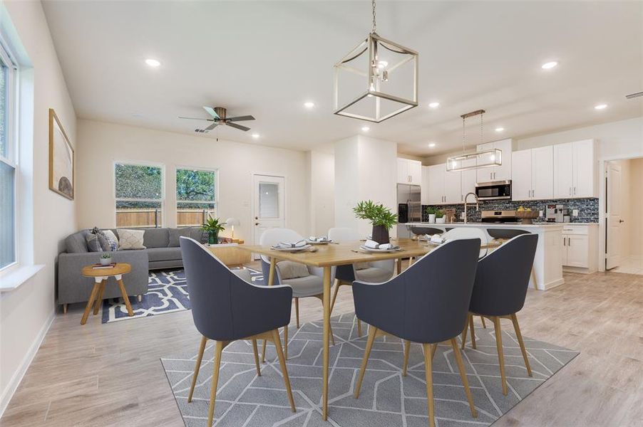 Dining room featuring a ceiling fan, recessed lighting, a chandelier, and light wood finished floors