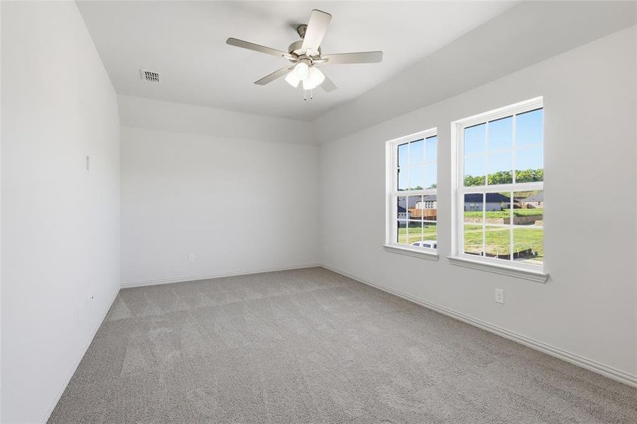 Spare room with light colored carpet and ceiling fan Spare room with light colored carpet and ceiling fan