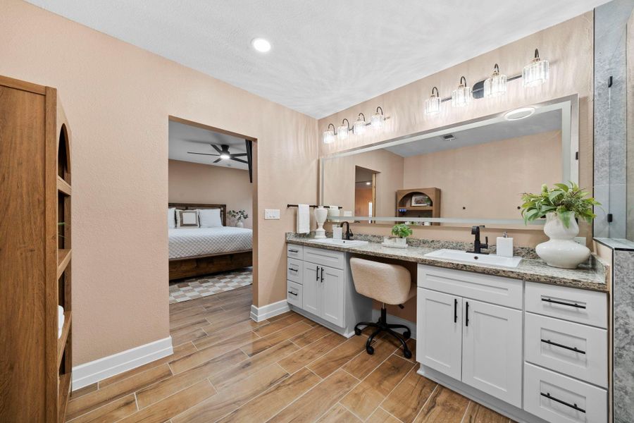 The massive double vanity offers plenty of room for two, while the built-in makeup station provides a dedicated space for your morning routine.