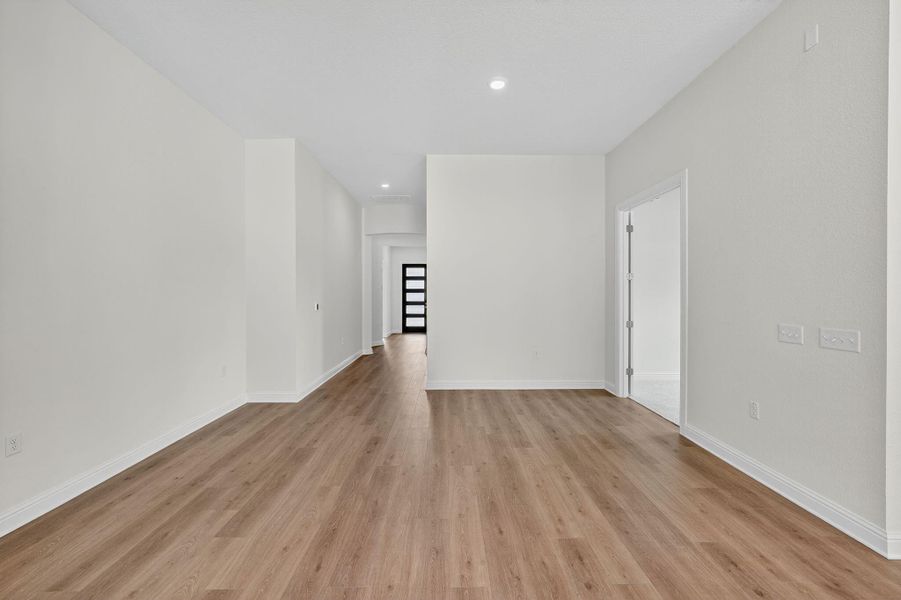 Spare room with light wood finished floors and recessed lighting Spare room with light wood finished floors and recessed lighting