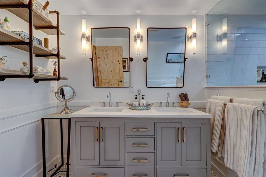 Dual vanities and wall hung mirrors in primary bath. 94 San Saba St Austin TX 78702 MLS# 7207900