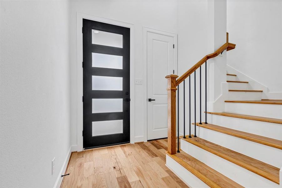 A view of the entry way facing back toward the front door. You'll love the bright and durable engineered wood floors. (Model Unit 9424C)