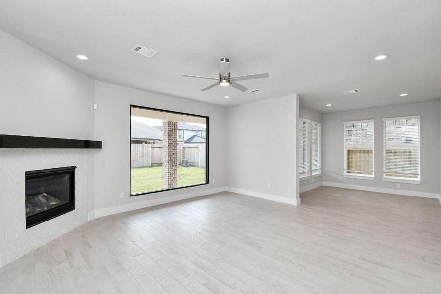 Relax and unwind in this inviting family room, illuminated by abundant natural light streaming in through the tall window, complemented by high ceilings and stunning flooring. Stay comfortable year-round with the gentle breeze from the ceiling fan, creating the perfect atmosphere for family gatherings. Relax and unwind in this inviting family room, illuminated by abundant natural light streaming in through the tall window, complemented by high ceilings and stunning flooring. Stay comfortable year-round with the gentle breeze from the ceiling fan, creating the perfect atmosphere for family gatherings.