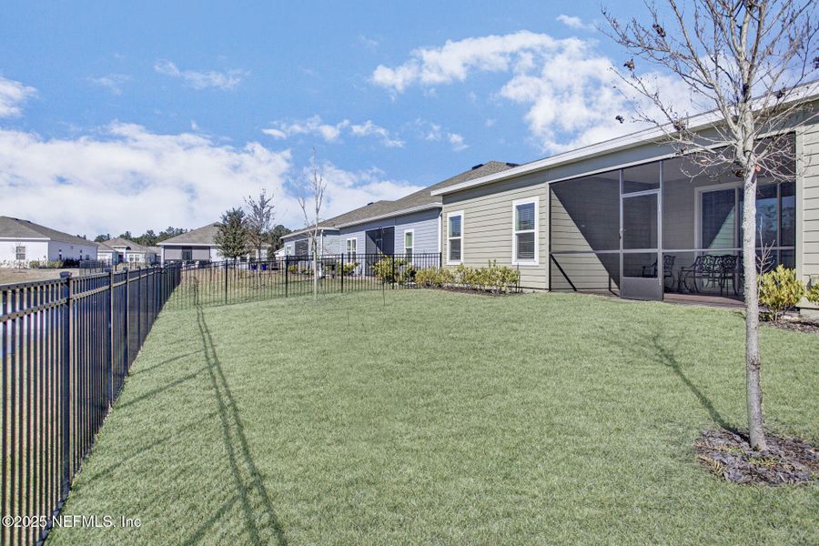 Exterior details and patio area of a home in Tributary: Lakeview at Tributary 60's, Yulee (Image 22).