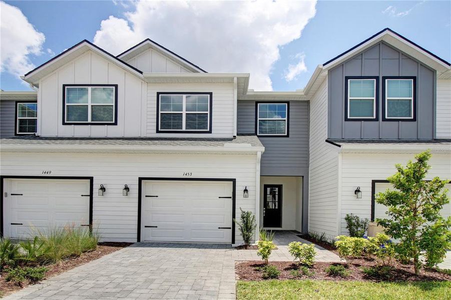 Front exterior of a new home in Brentwood Landing, Oviedo, FL, highlighting curb appeal (Image 1). Front exterior of a new home in Brentwood Landing, Oviedo, FL, highlighting curb appeal (Image 1).