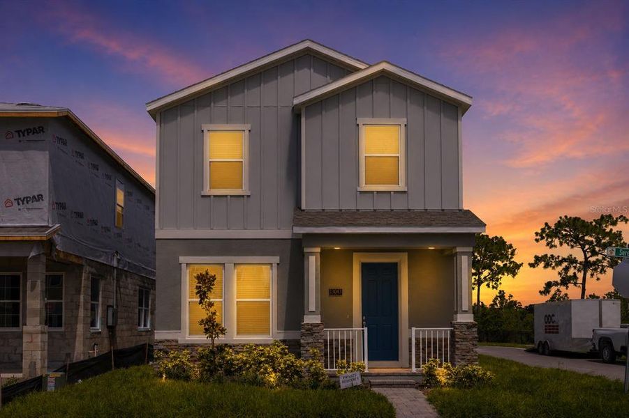 Front exterior of a new home in Serenade at Ovation, Winter Garden, FL, highlighting curb appeal (Image 19). Front exterior of a new home in Serenade at Ovation, Winter Garden, FL, highlighting curb appeal (Image 19).
