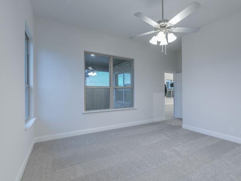 Unfurnished room featuring carpet flooring and ceiling fan