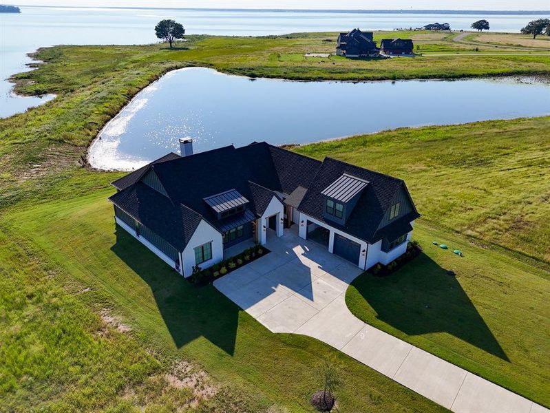 Aerial view of property and surrounding area with a large body of water Aerial view of property and surrounding area with a large body of water