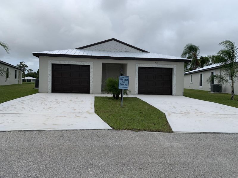Front exterior of a new home in , Fort Pierce, FL, highlighting curb appeal (Image 1). Front exterior of a new home in , Fort Pierce, FL, highlighting curb appeal (Image 1).