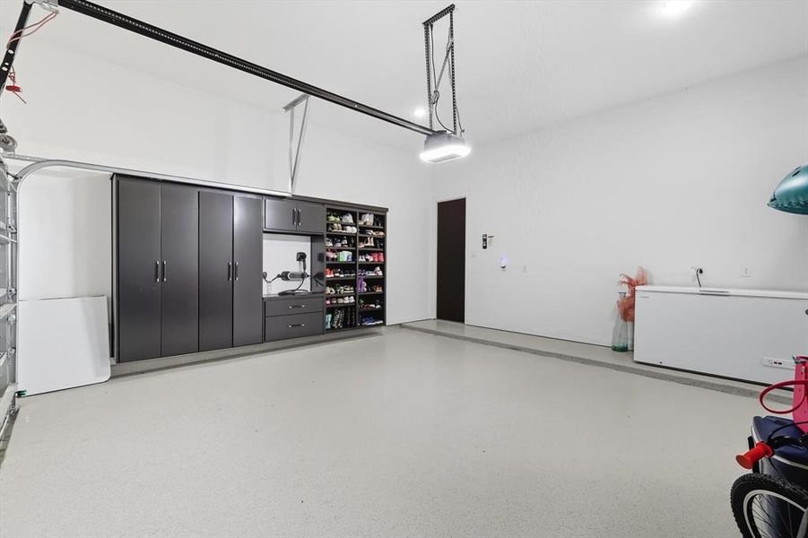 3-car garage featuring several built-in cabinets (4th garage bay is seperate from this area) 3-car garage featuring several built-in cabinets (4th garage bay is seperate from this area)