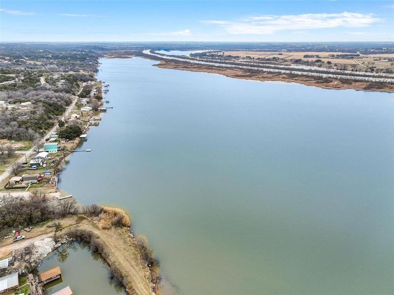 Birds eye view of property with a water view