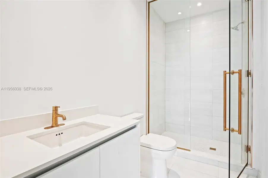 Bright and stylish second bathroom with sleek cabinetry, contemporary lighting, spa-inspired shower, and refined modern finishes.