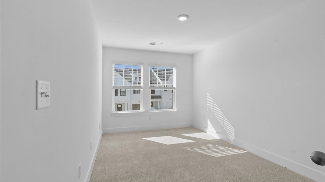 Superior comfort in a secondary bedroom with plush carpet and an oversized walk-in closet in Simpsonville, SC