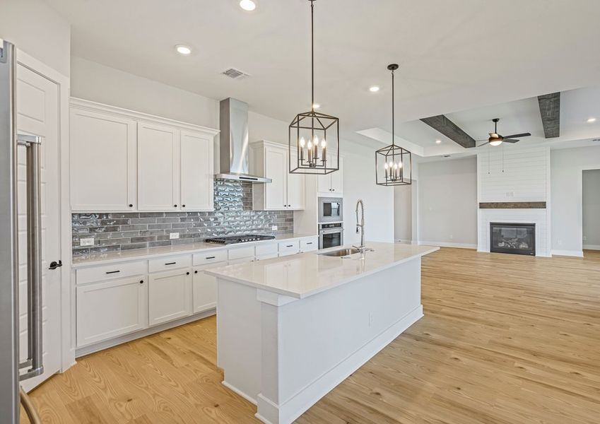 The kitchen has sprawling quartz countertops.