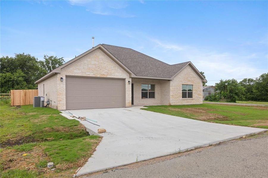 Front exterior of a new home in , Tom Bean, TX, highlighting curb appeal (Image 17). Front exterior of a new home in , Tom Bean, TX, highlighting curb appeal (Image 17).