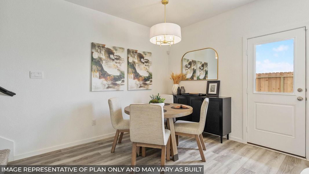 Dining area featuring wood-finish flooring, a contemporary chandelier, and a glass-paneled door