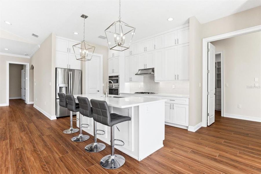 Open Kitchen with door to walk-in Pantry in corner.