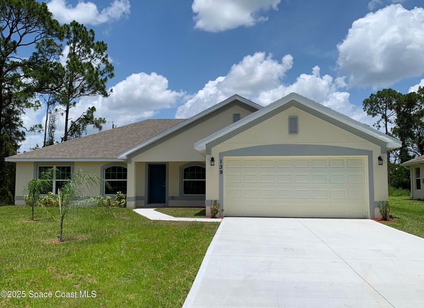 Front exterior of a new home in Palm Bay, Palm Bay, FL, highlighting curb appeal (Image 1).