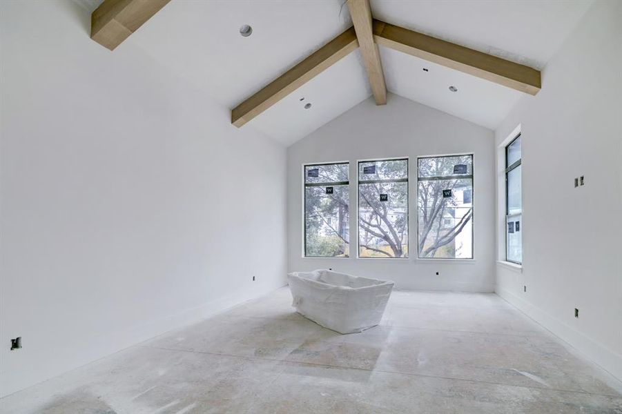 Spacious master suite! Stained beams on the vaulted ceiling. Wood floors and gold hanging fixture to be installed.