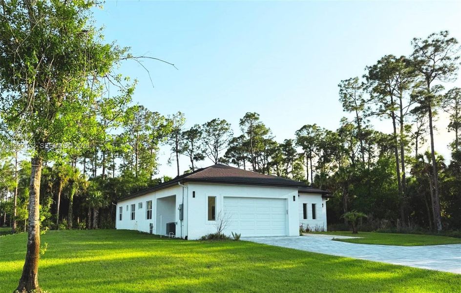 Front exterior of a new home in , Naples, FL, highlighting curb appeal (Image 26).