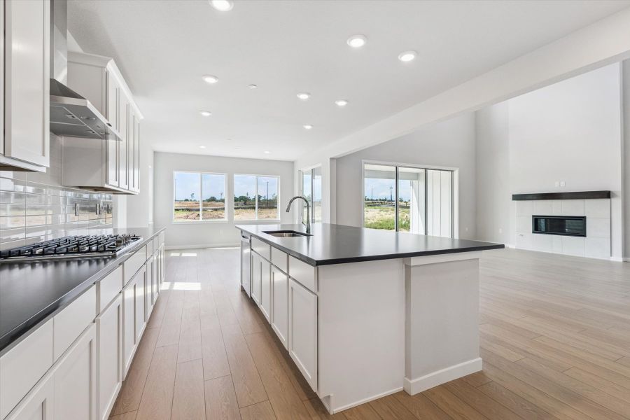 A kitchen with white cabinets.