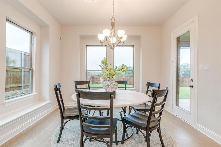 Dining room featuring a chandelier and light hardwood / wood-style floors