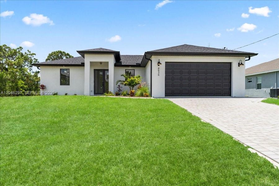 Front exterior of a new home in , Cape Coral, FL, highlighting curb appeal (Image 2). Front exterior of a new home in , Cape Coral, FL, highlighting curb appeal (Image 2).