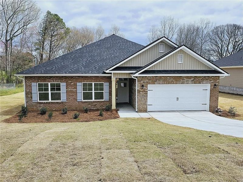 Front exterior of a new home in Scarlett Place, Bowdon, GA, highlighting curb appeal (Image 1).
