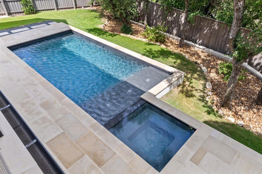 View of swimming pool featuring an in-ground hot tub and a fenced backyard View of swimming pool featuring an in-ground hot tub and a fenced backyard