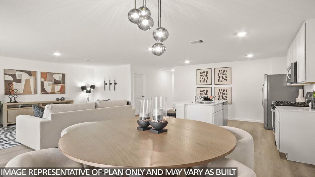 Dining area with light wood-style flooring and recessed lighting