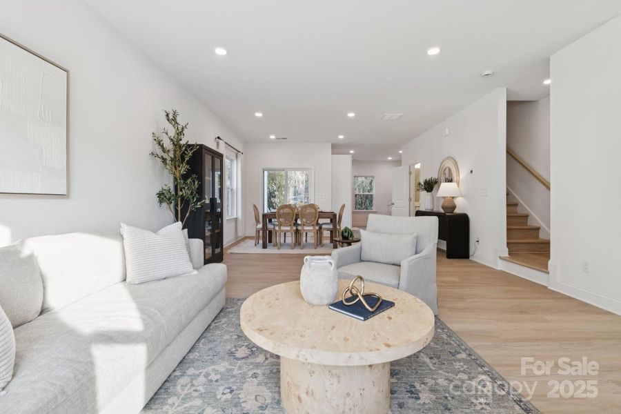 9' ceilings, light oak-colored LVP flooring, recessed lights, and tons of natural light fills this open-concept living space