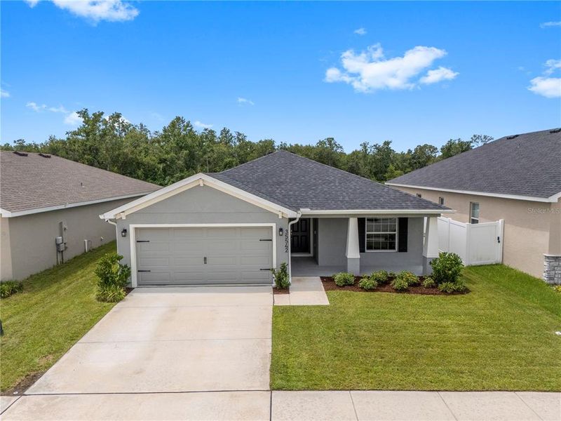 Front exterior of a new home in Stonebridge North, Zephyrhills, FL, highlighting curb appeal (Image 24). Front exterior of a new home in Stonebridge North, Zephyrhills, FL, highlighting curb appeal (Image 24).