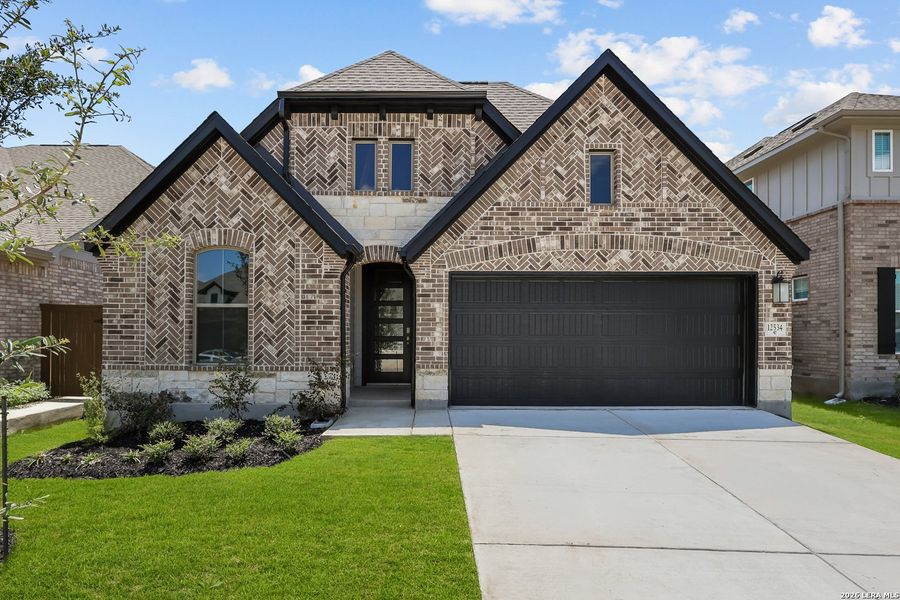 Front exterior of a new home in Stillwater Ranch, San Antonio, TX, highlighting curb appeal (Image 27).
