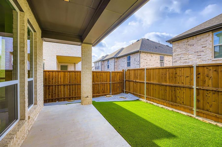 Fenced backyard with a patio area