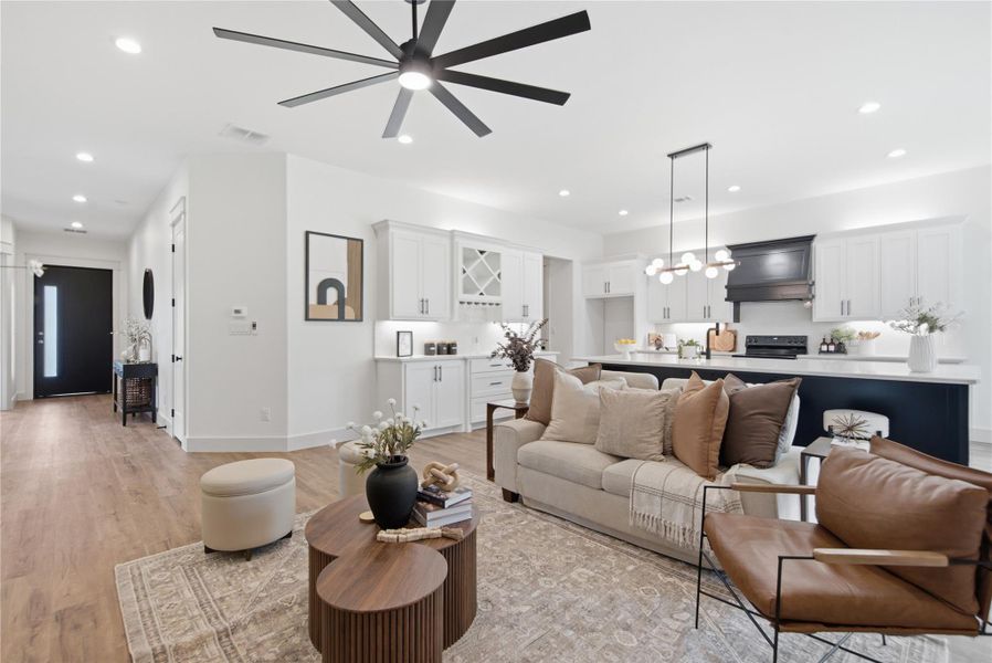 An open-concept design seamlessly connects the living room and kitchen, ideal for modern entertaining. An open-concept design seamlessly connects the living room and kitchen, ideal for modern entertaining.