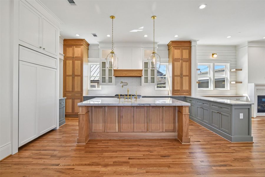 The kitchen from a straight on perspective. The refrigerator is a built in panel ready (not completed / no hardware yet). The kitchen from a straight on perspective. The refrigerator is a built in panel ready (not completed / no hardware yet).