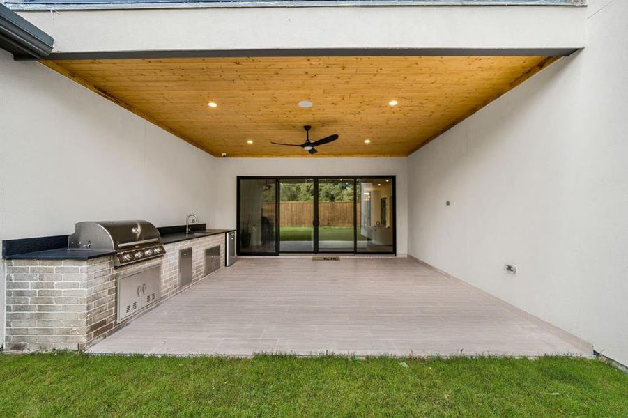 View of patio / terrace with ceiling fan and area for grilling