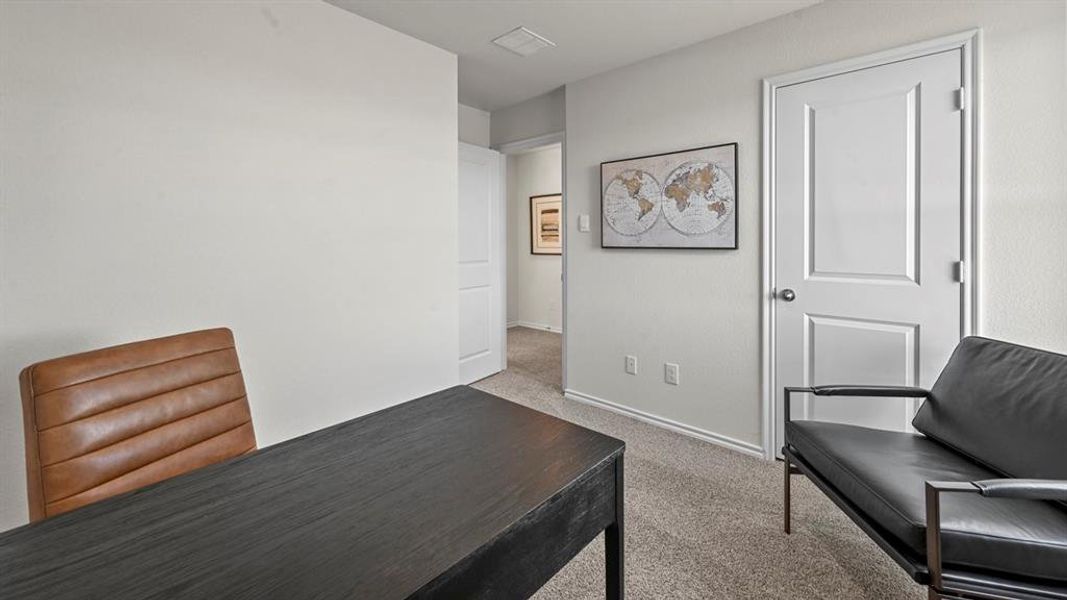 Office featuring light colored carpet and baseboards