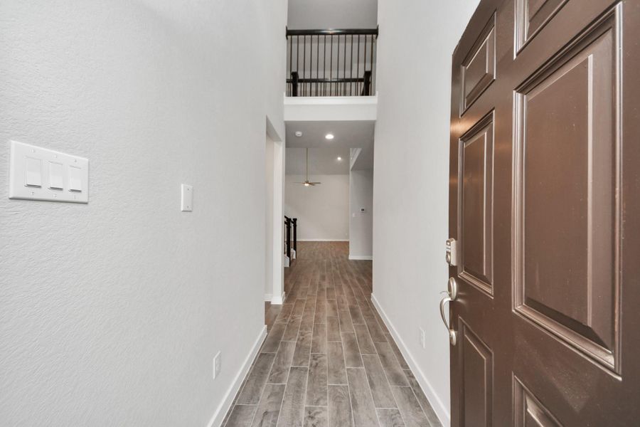 As you step into the threshold of this luxurious home, you'll soon be welcomed by an elegant glass door (to be installed). Inside, soaring ceilings amplify the spaciousness, while the refined wood-look tile flooring and oversized baseboards exude sophistication and charm. As you step into the threshold of this luxurious home, you'll soon be welcomed by an elegant glass door (to be installed). Inside, soaring ceilings amplify the spaciousness, while the refined wood-look tile flooring and oversized baseboards exude sophistication and charm.