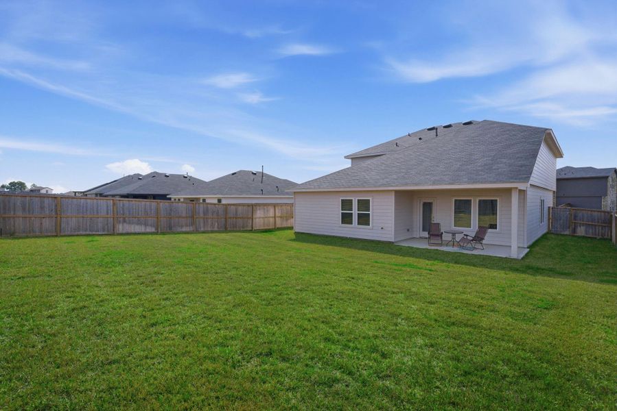 Backyard view showcasing the home’s 7,795 sq ft lot footprint.
